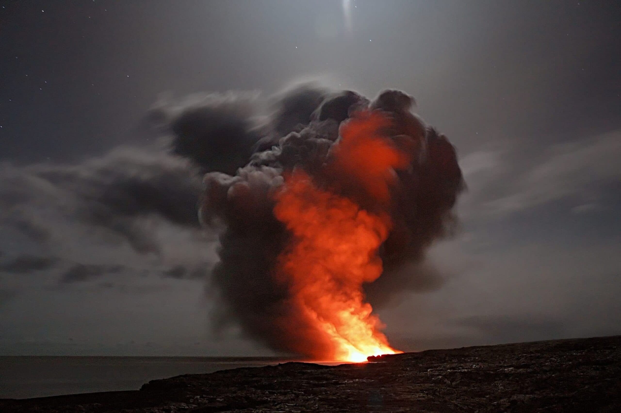 A volcanic eruption glowing against a night sky